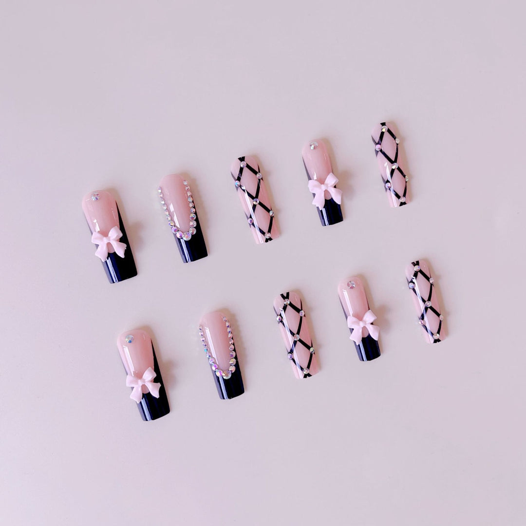Artificial nail set with glamorous rhinestone and bow accents Kalsten