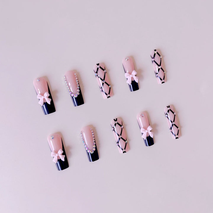 Artificial nail set with glamorous rhinestone and bow accents Kalsten