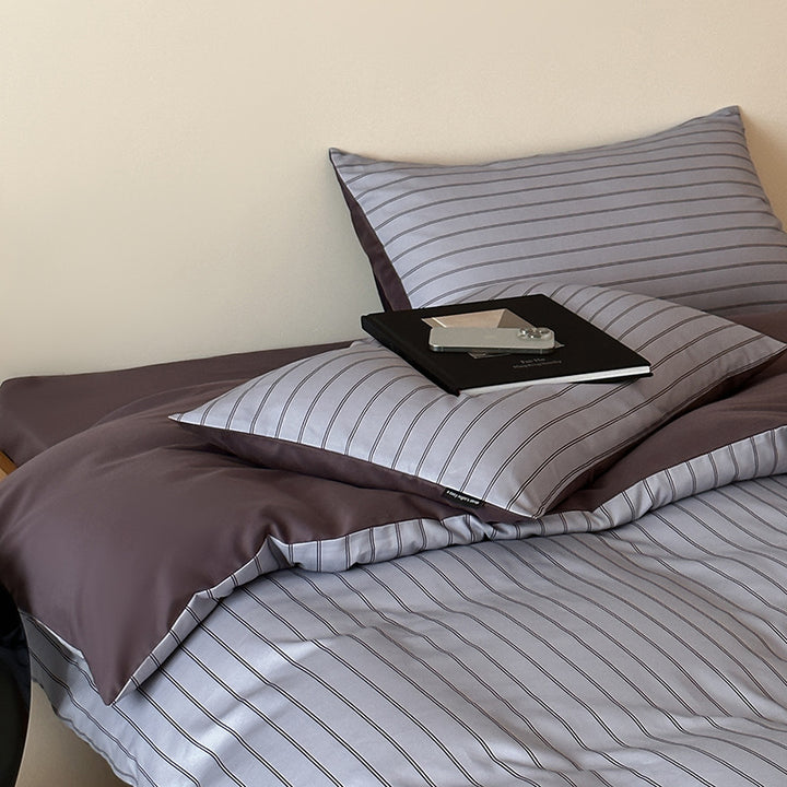 Reversible cotton satin bedding set with fine striped pattern and contrasting backside