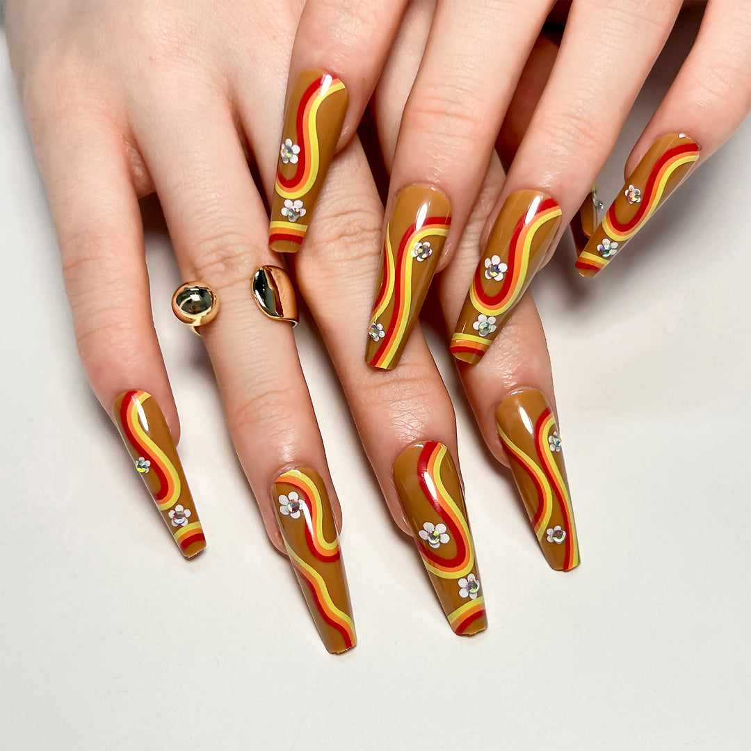 Artful acrylic nails with wave design and floral embellishments Kalsten