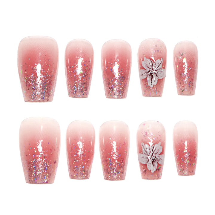 Artificial nail extensions with floral design and glitter accents Kalsten