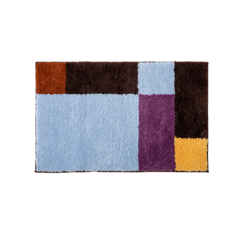 High-pile bath mat with geometric color block design and non-slip underside