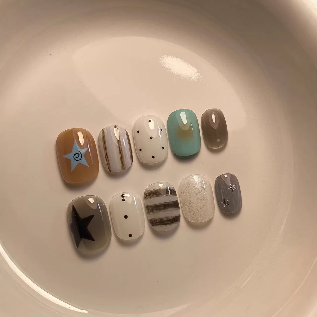 Artistic Press-On Nail Set with Abstract Patterns and Decorative Elements