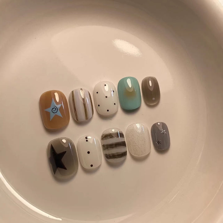 Artistic Press-On Nail Set with Abstract Patterns and Decorative Elements