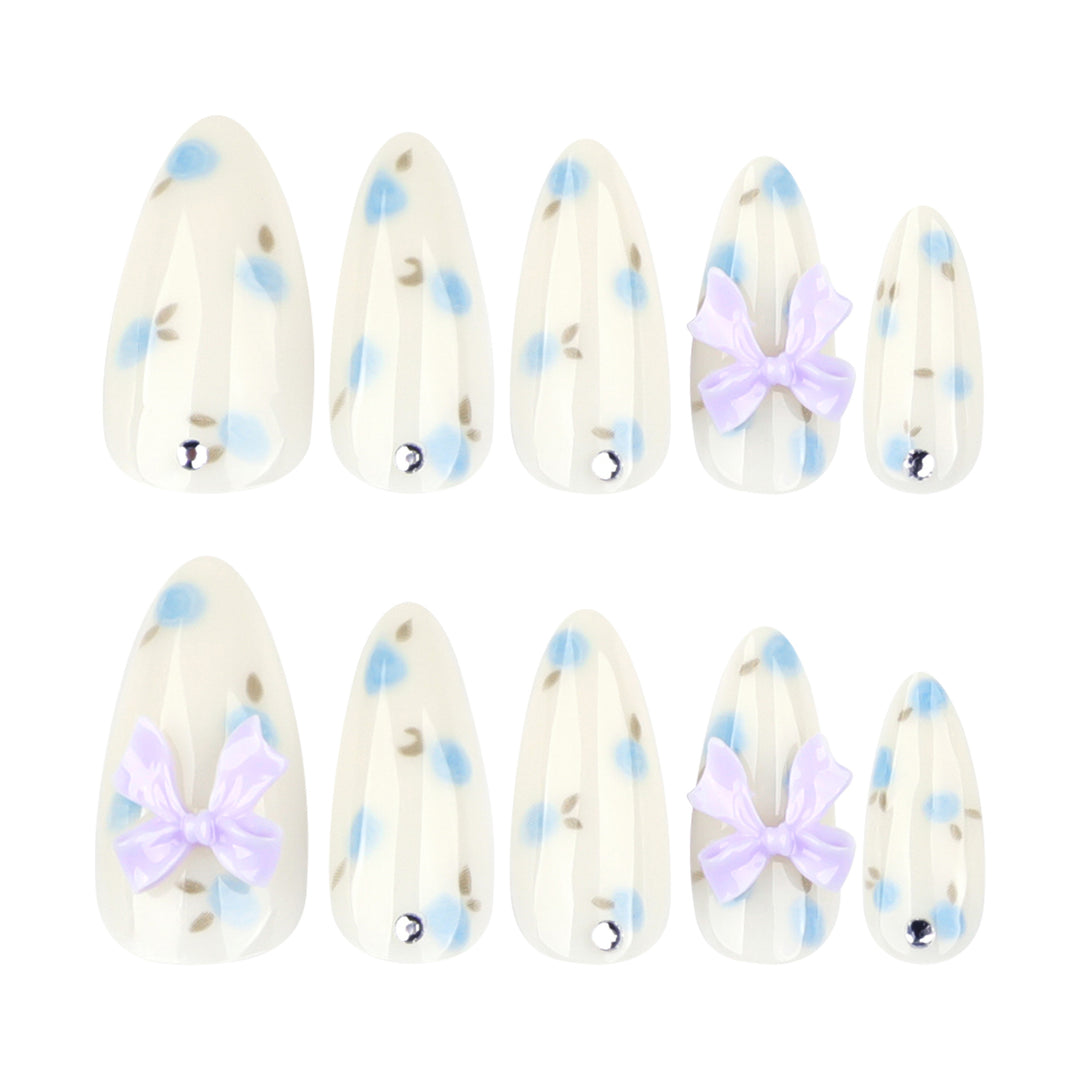 Artful stiletto nails with delicate flower patterns and glitter accents Kalsten