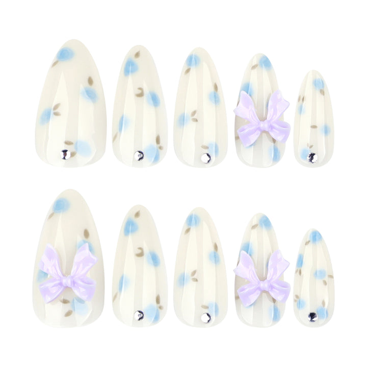 Artful stiletto nails with delicate flower patterns and glitter accents Kalsten