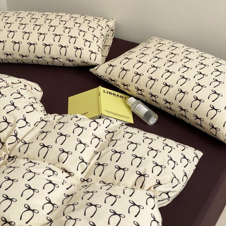 Light cotton bedding set with quilted topper and fine stripe pattern