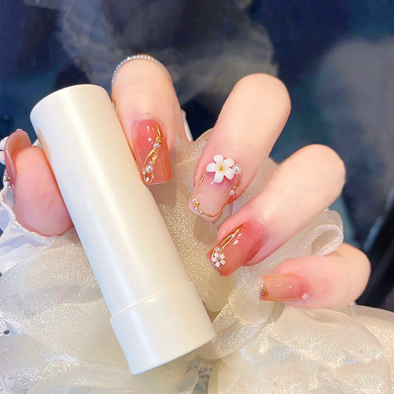 Acrylic nail set with elegant floral decorations and glamorous pearl accents Kalsten