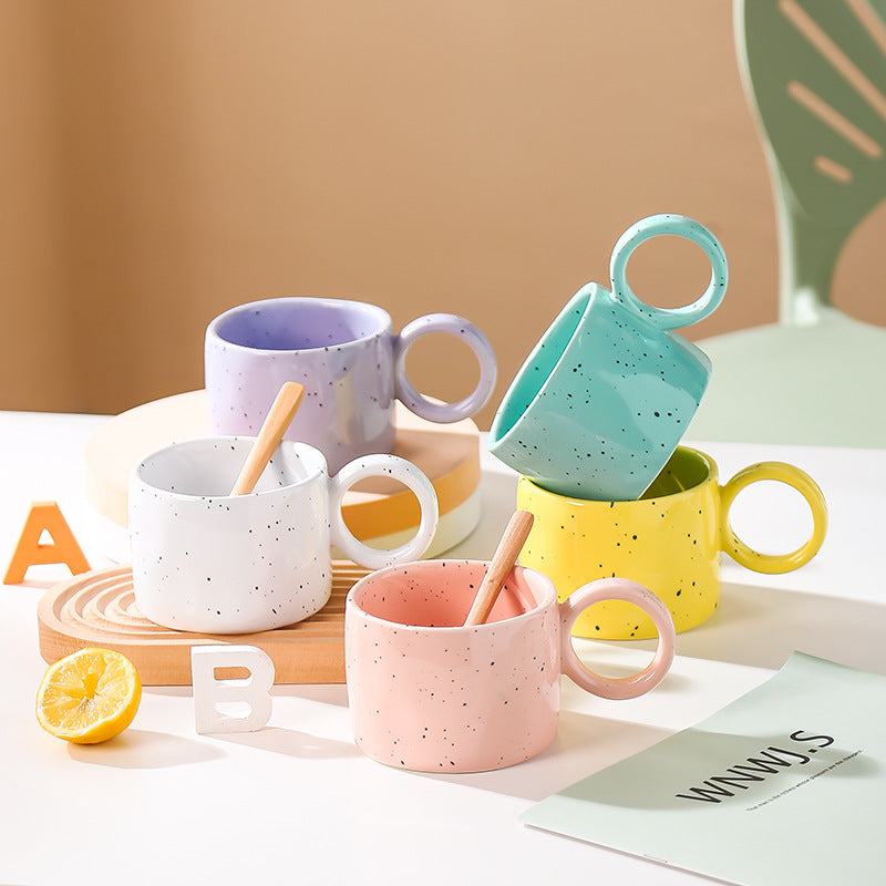 Ceramic mug with heart-shaped handle and speckle design