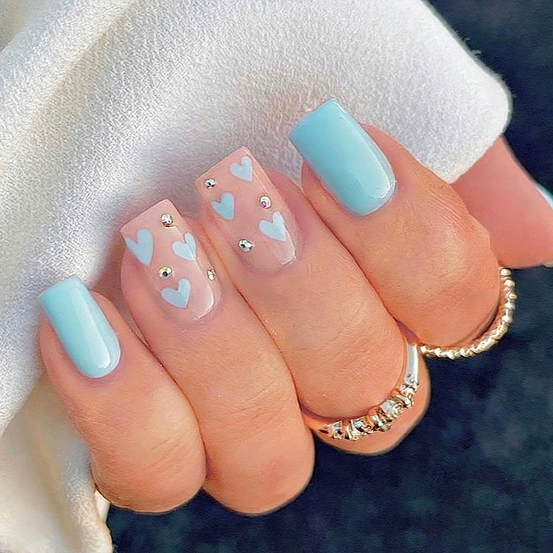 Nail art with heart designs and glitter accents Kalsten