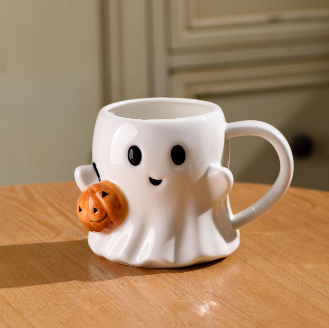 Ceramic mug with 3D ghost shape and pumpkin appliqué