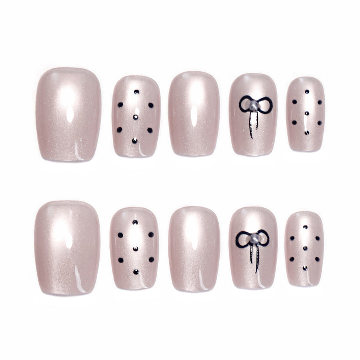 Artificial nail extensions with decorative bows and dots Kalsten