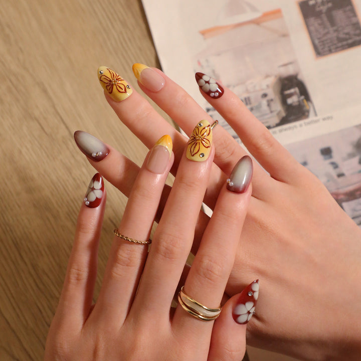 Artificial nail extensions with floral design and rhinestone embellishments Kalsten
