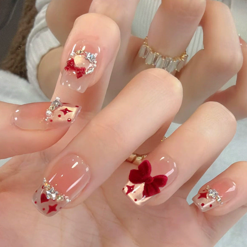 Artificial nail set with festive gift design and elegant glitter accents Kalsten