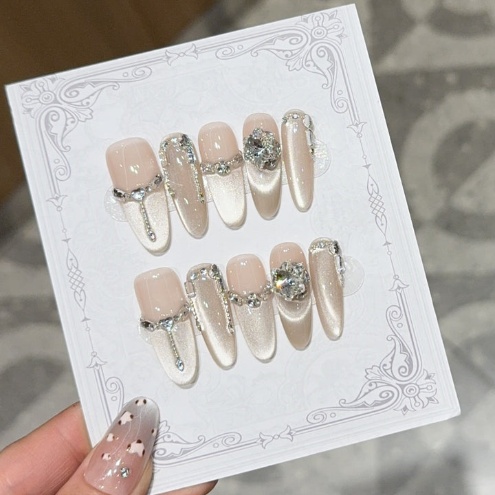 Glamorous nail tips with rhinestone and glitter effects Kalsten