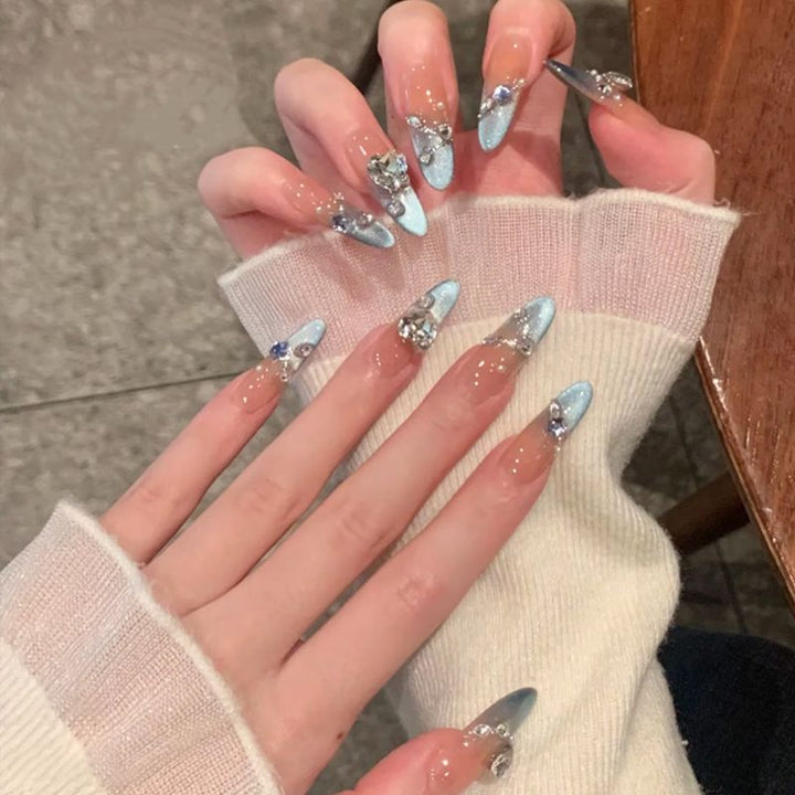 Acrylic nail set with elegant tips and glamorous rhinestone accents Kalsten