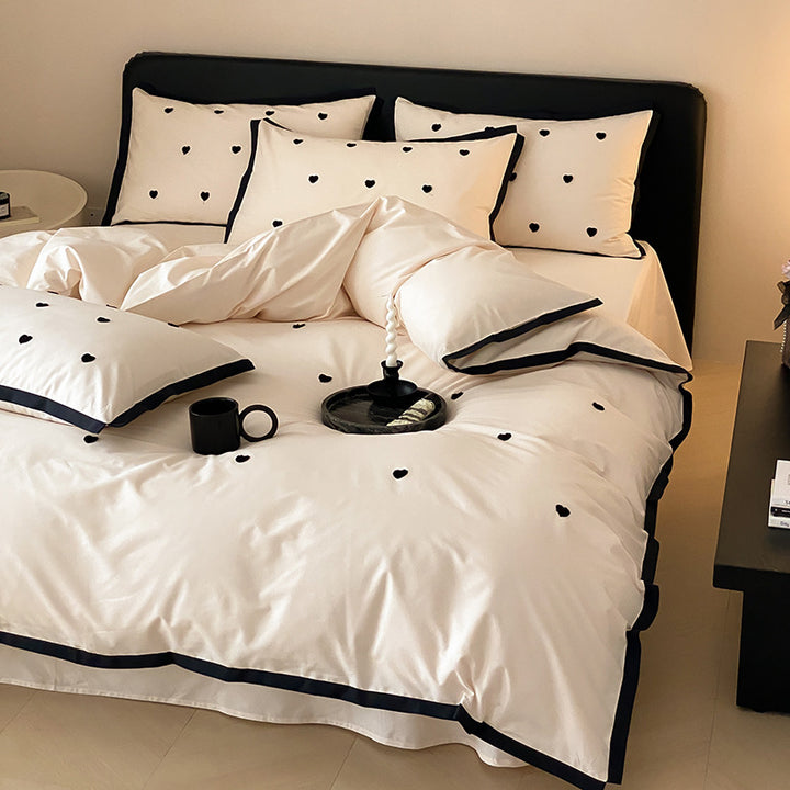 High-quality cotton satin bedding set with delicate embroidery, reversible feature & piping edge