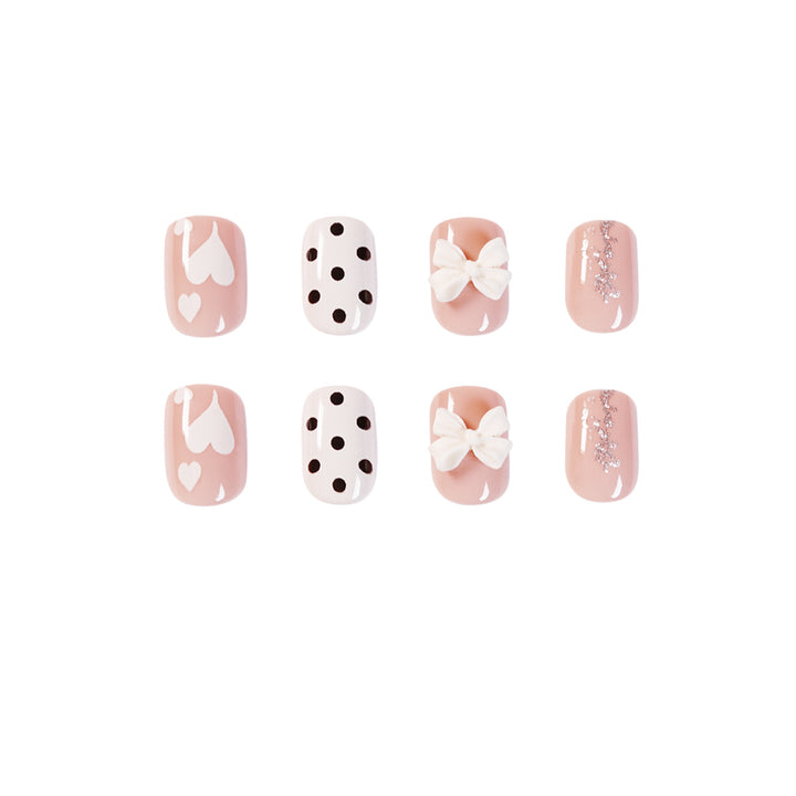 Artful nail art with delicate flower and heart motifs Kalsten