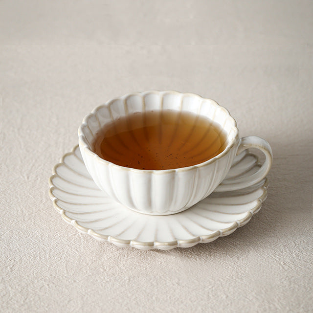 Fine porcelain tea cup set with ribbed shell edge and sculptural handle