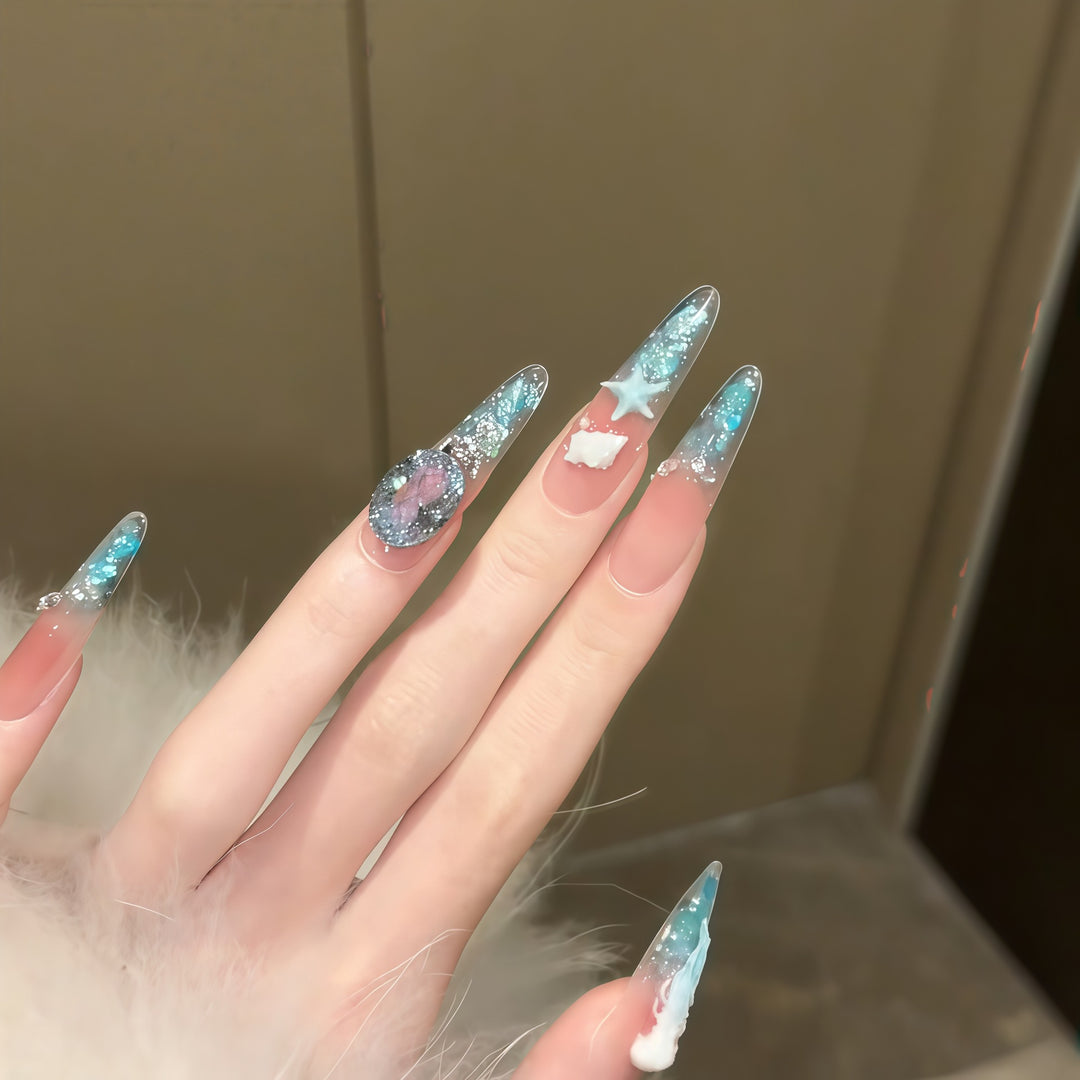 Creative artificial nails with maritime designs and sparkling accents Kalsten