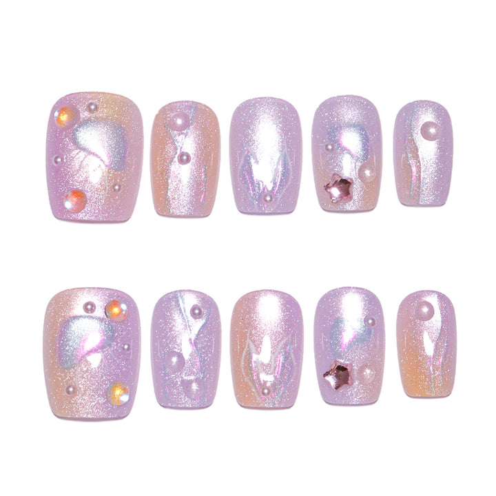 Artificial nail art with sparkling accents and transparent color gradient Kalsten