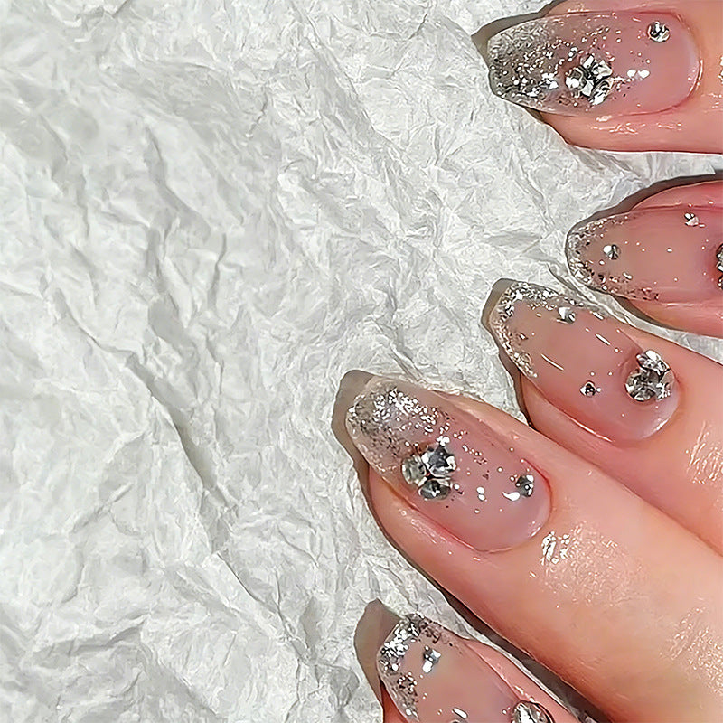 Glamorous artificial nails with glitter and rhinestone embellishments Kalsten