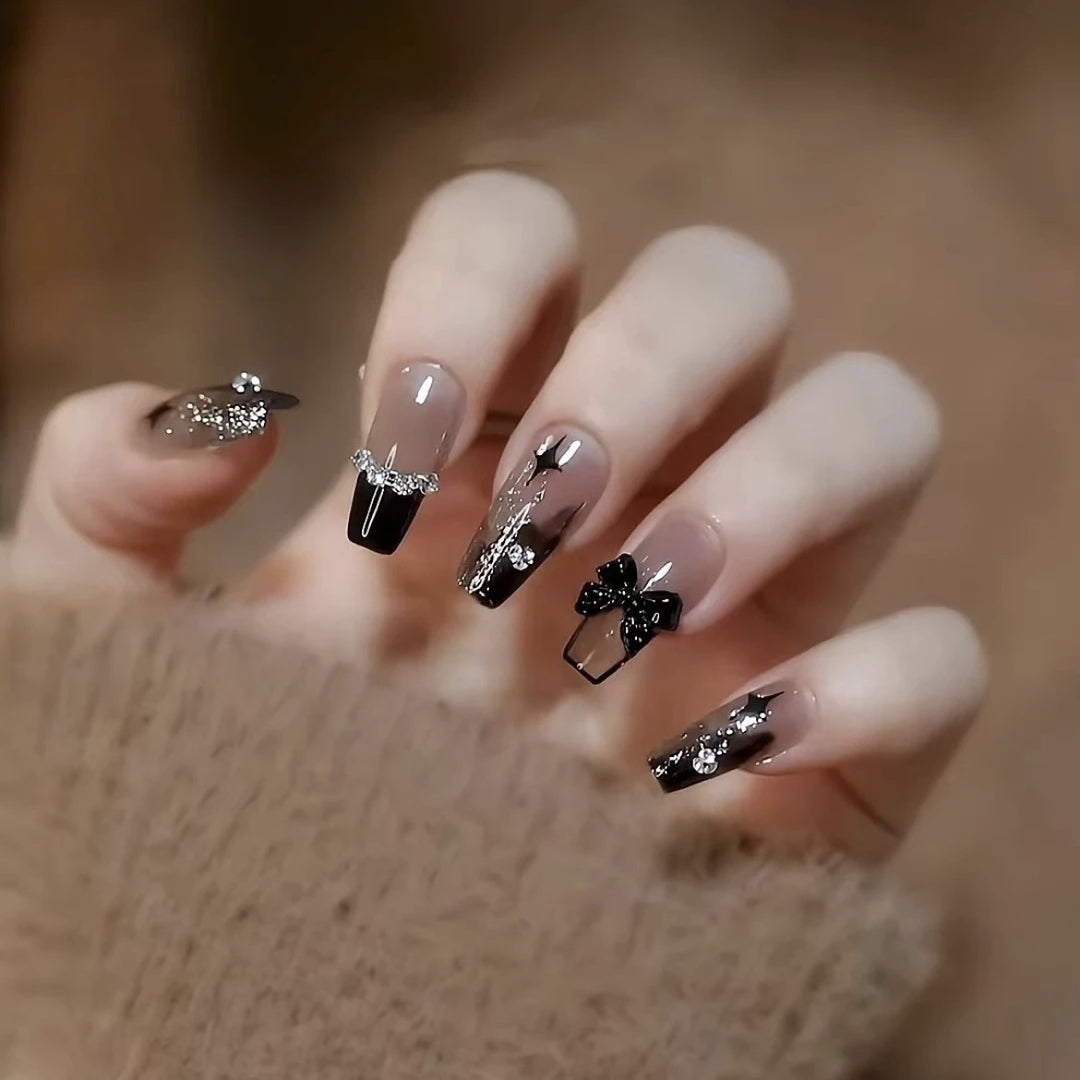 Elegant nail design with bow and rhinestone details Kalsten