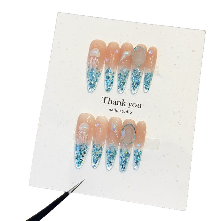 Creative artificial nails with maritime designs and sparkling accents Kalsten