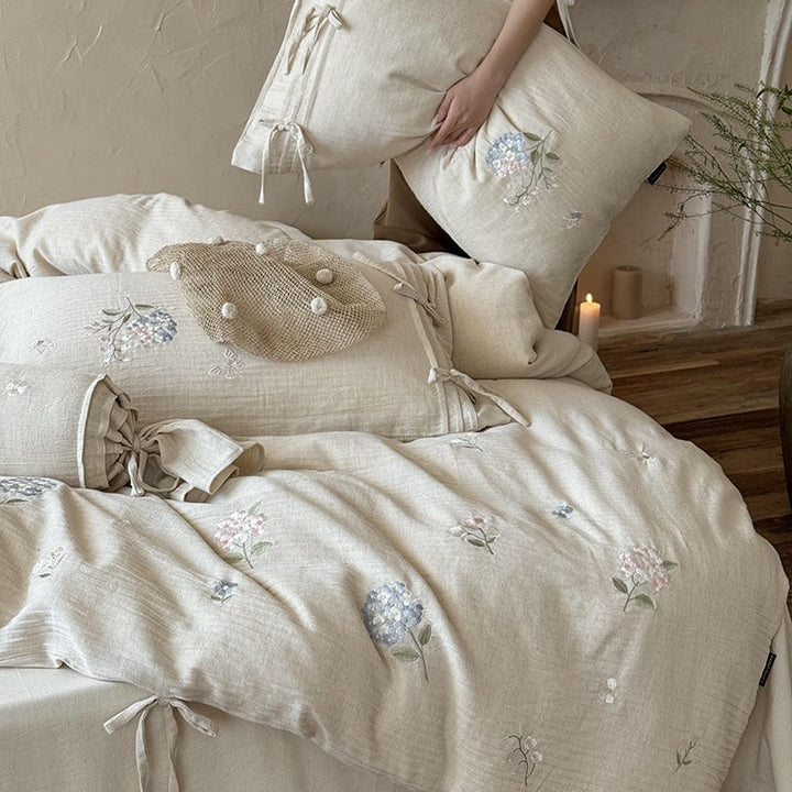 Embroidered cotton-linen bedding set with decorative ribbons and fine floral design