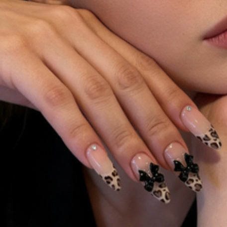 Creative artificial nails with stylish leopard pattern and bow accents Kalsten