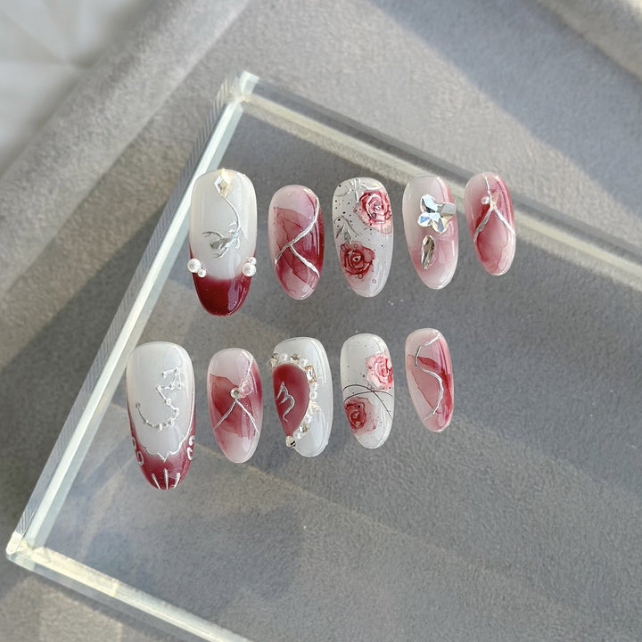 Artistic Press-On Nail Set with Floral Designs and Gem Accents