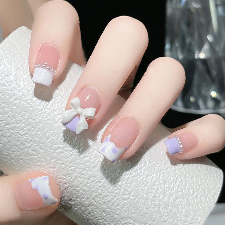 Nail art set with elegant wave patterns and delicate pearl accents Kalsten
