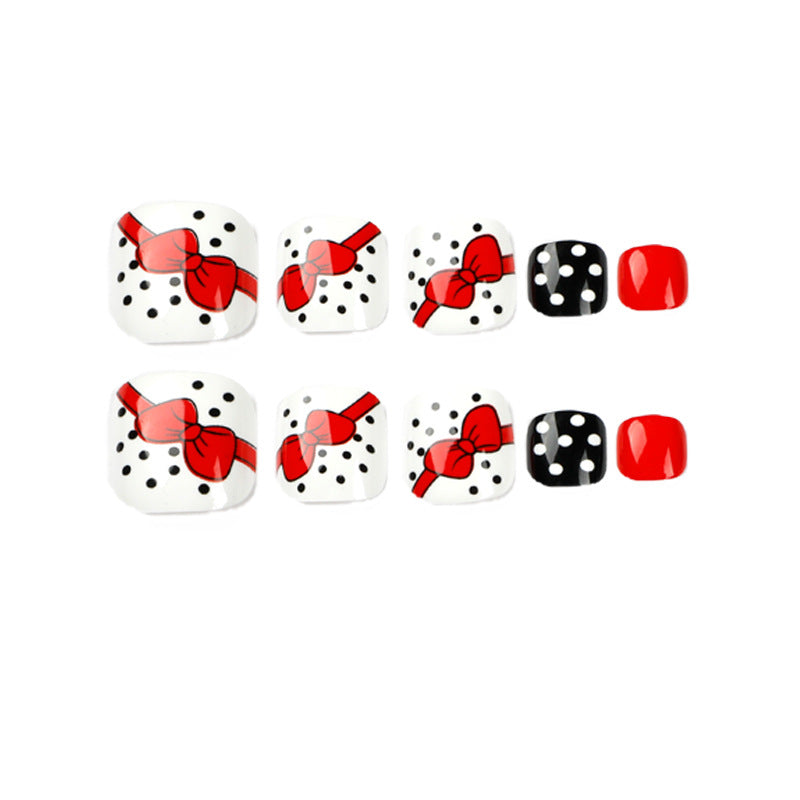 Artful toenail design with elegant bow motifs Kalsten