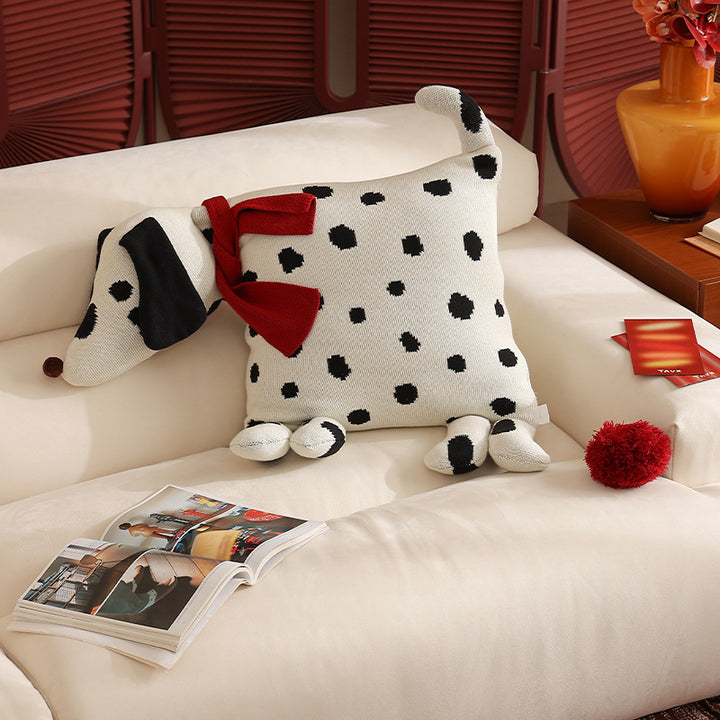 Decorative knitted cuddle pillow in the shape of a dog with a quilted body and bow detail Kalsten