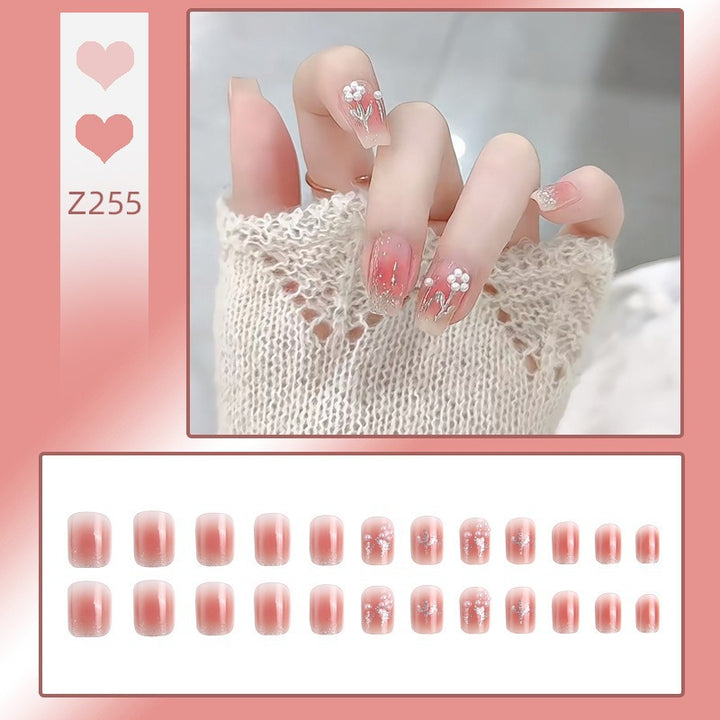Artificial nail set with floral designs and glitter accents Kalsten
