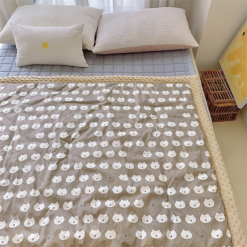 Children's quilt with colorful dinosaur print and soft minky border