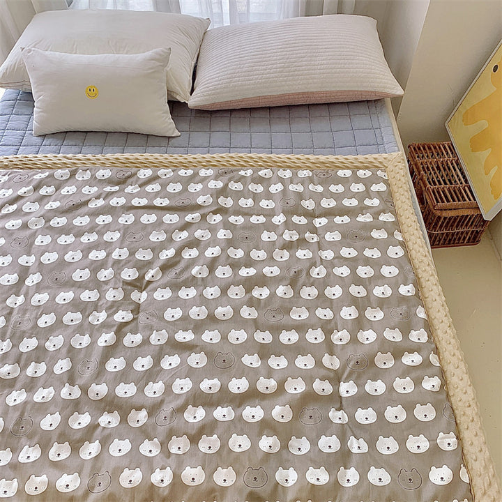 Children's quilt with colorful dinosaur print and soft minky border