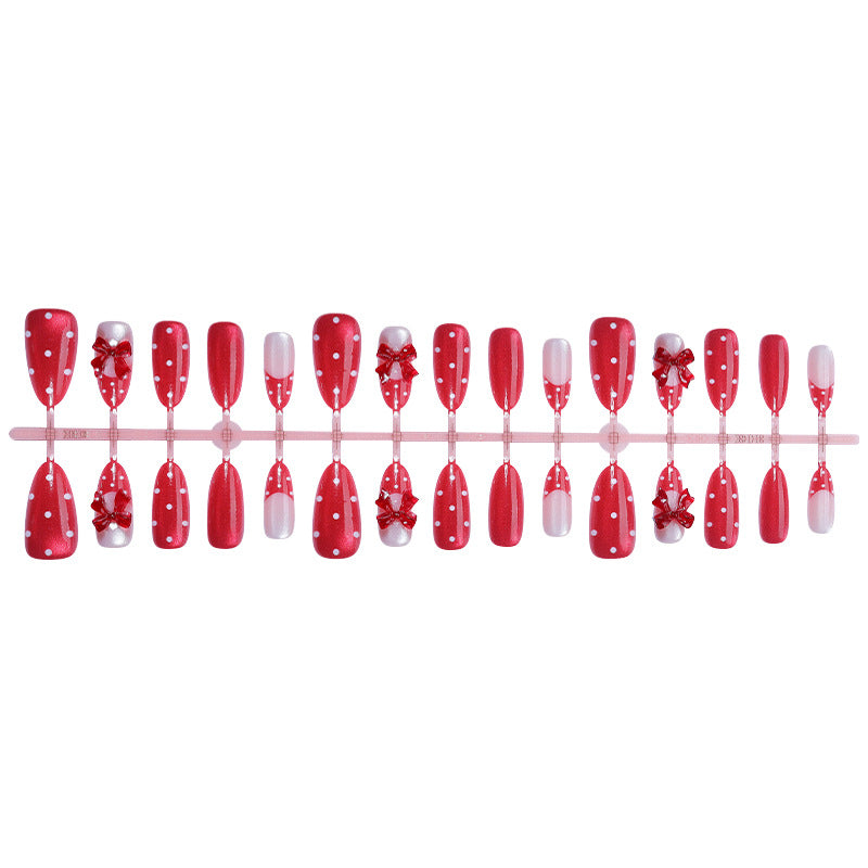 Nail set with playful red polka dots and bow accents Kalsten