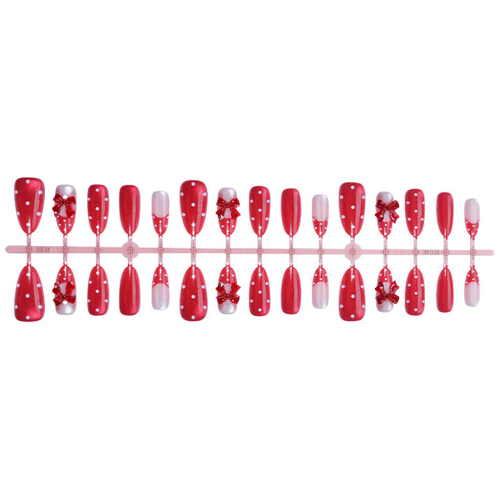Nail set with playful red polka dots and bow accents Kalsten