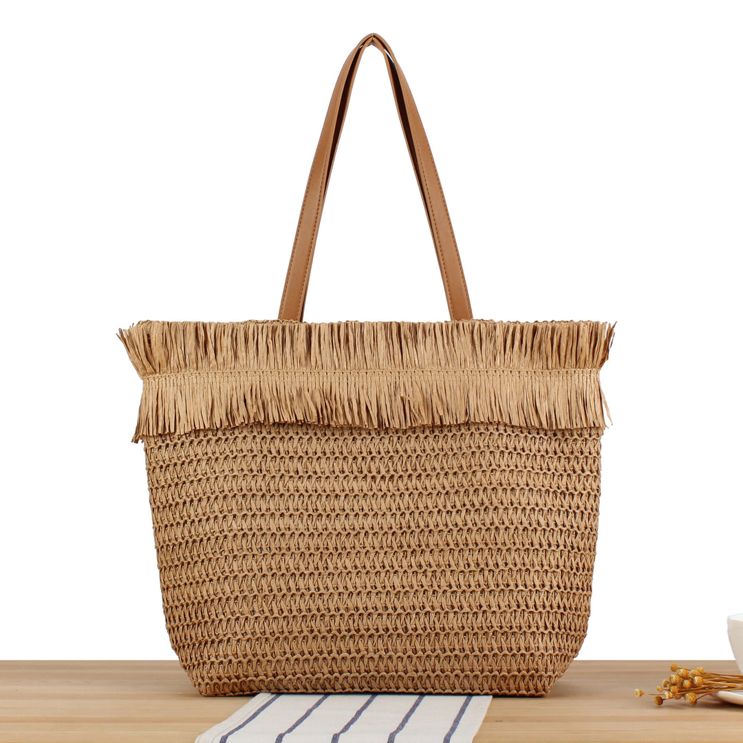 Beach bag made of handwoven natural material with fringe decoration Kalsten