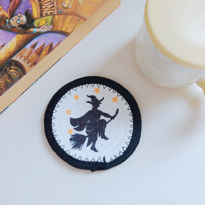 Round felt and cotton coasters with embroidered Halloween haunted house motif