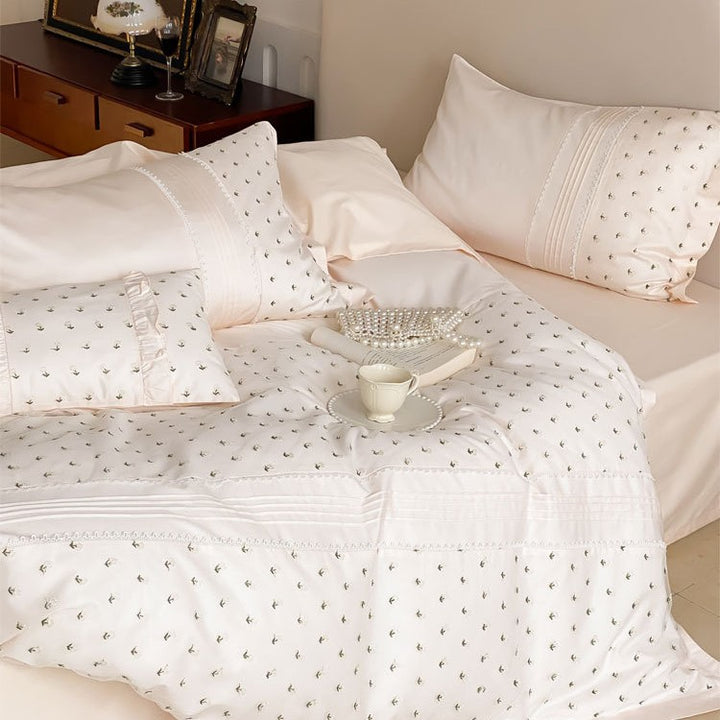 Exclusive satin bedding set with all-over rosebud embroidery and pleating details