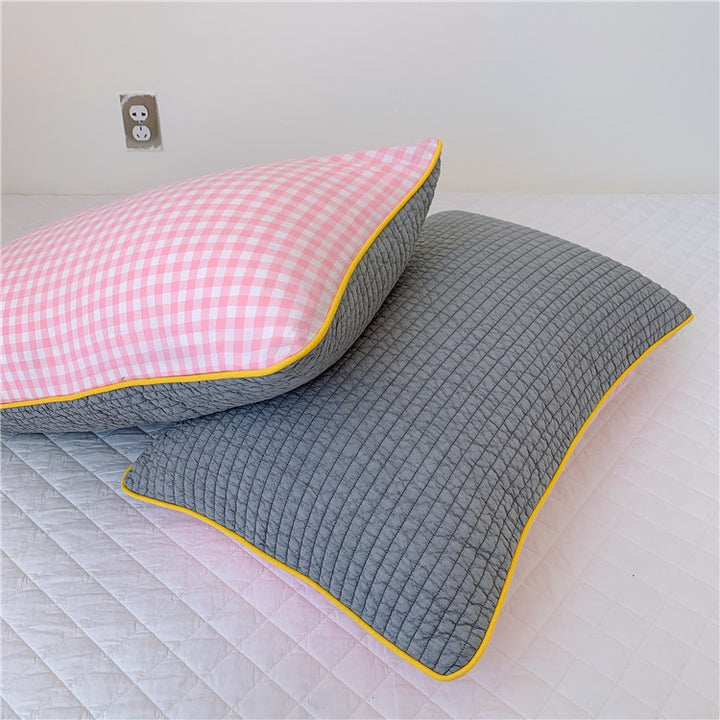 Reversible quilted pillow set with checked cotton cover and contrasting piping