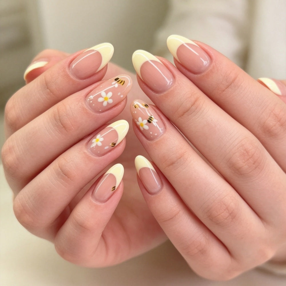 Artificial nails with elegant French tip and floral accents Kalsten