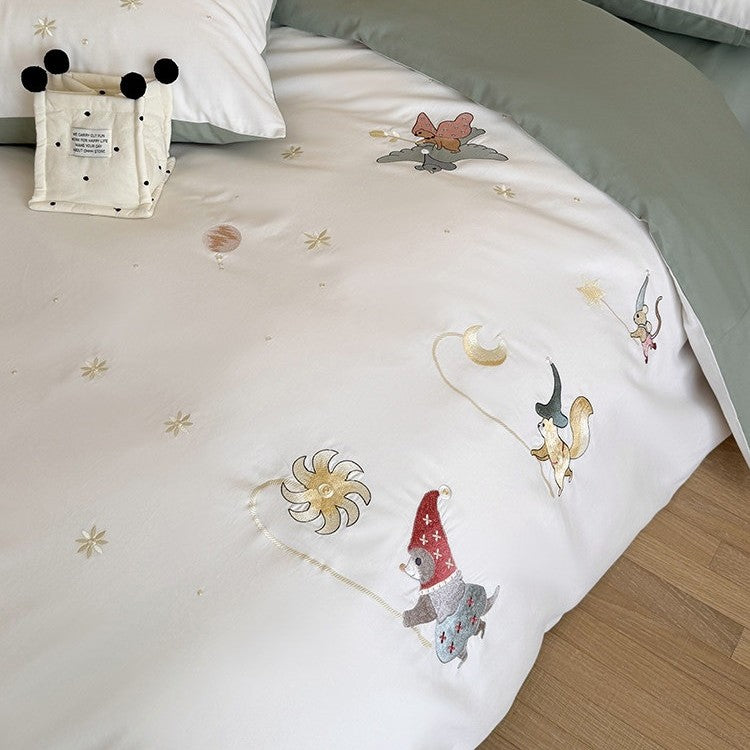 Children's bedding set with embroidered fairy tale forest motifs and reversible option