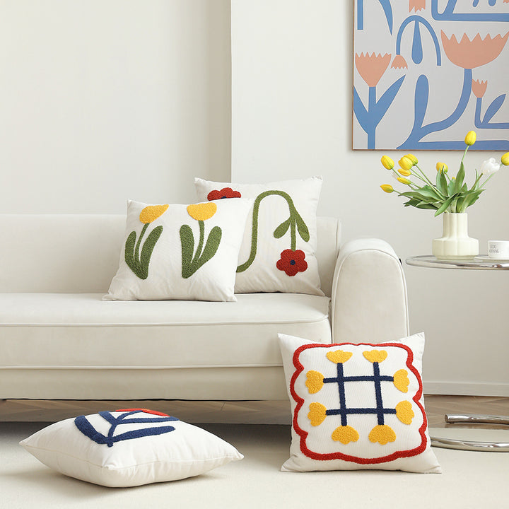 Square decorative cushion with hand-tufted heart ornament and contrasting border
