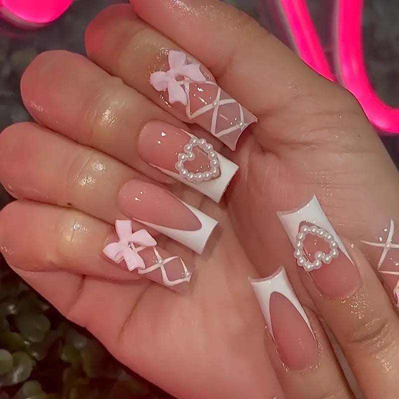 Elegant artificial nail tips with heart and bow accents Kalsten