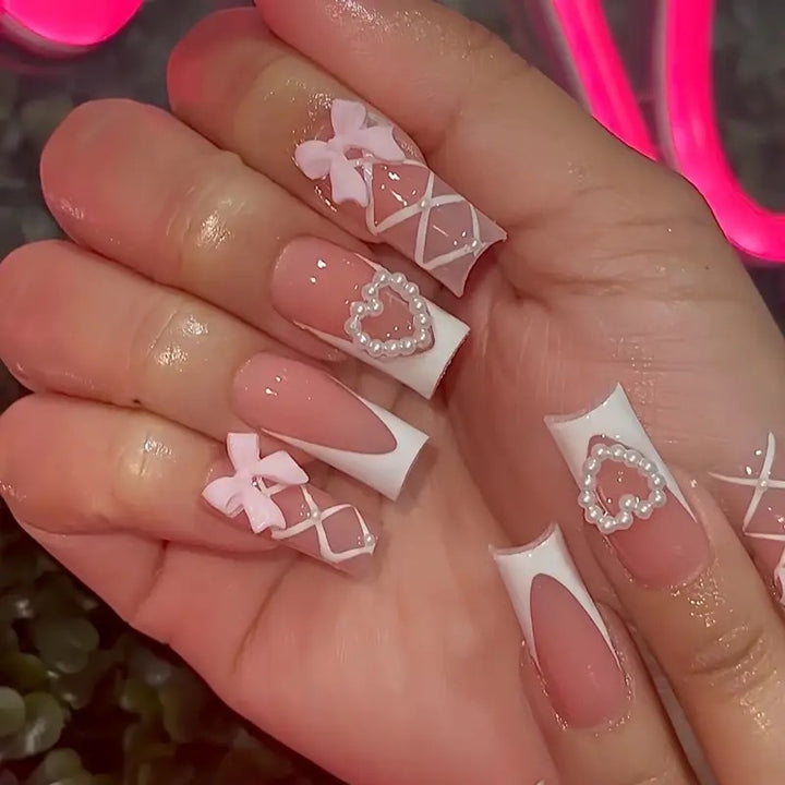 Elegant artificial nail tips with heart and bow accents Kalsten