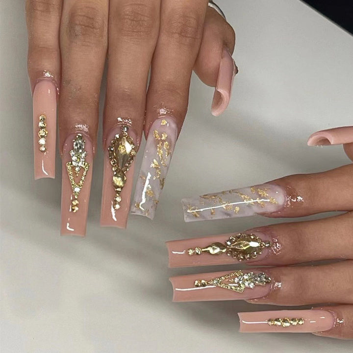 Artful nail extensions with glitter embellishments and delicate accents Kalsten
