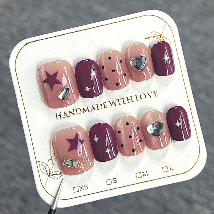 Artificial nail extensions with unique jewelry accents Kalsten